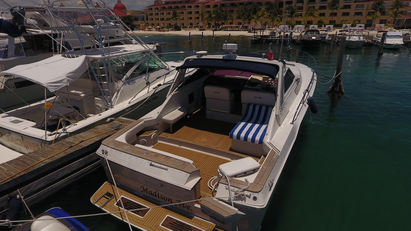 Sea Ray 47 ft party charter with guests celebrating on deck turquoise water Cancun