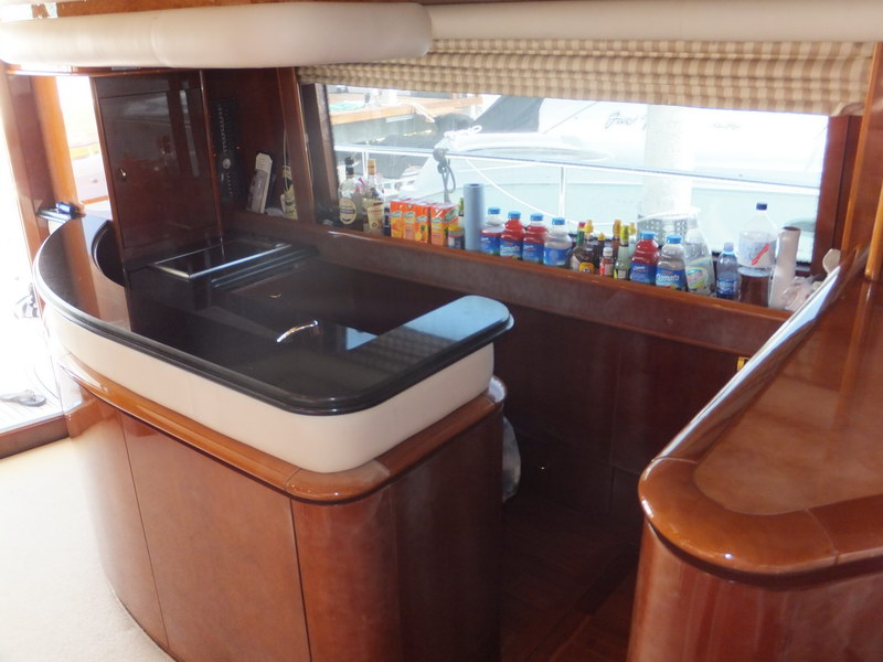 Galley service bar of Nuvaris 63 ft luxury yacht with black granite counter and beverages stocked for charter guests