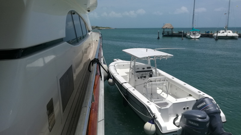 Azimut 100 ft mega yacht with Yamaha-powered Zodiac tender dinghy docked at Isla Mujeres marina