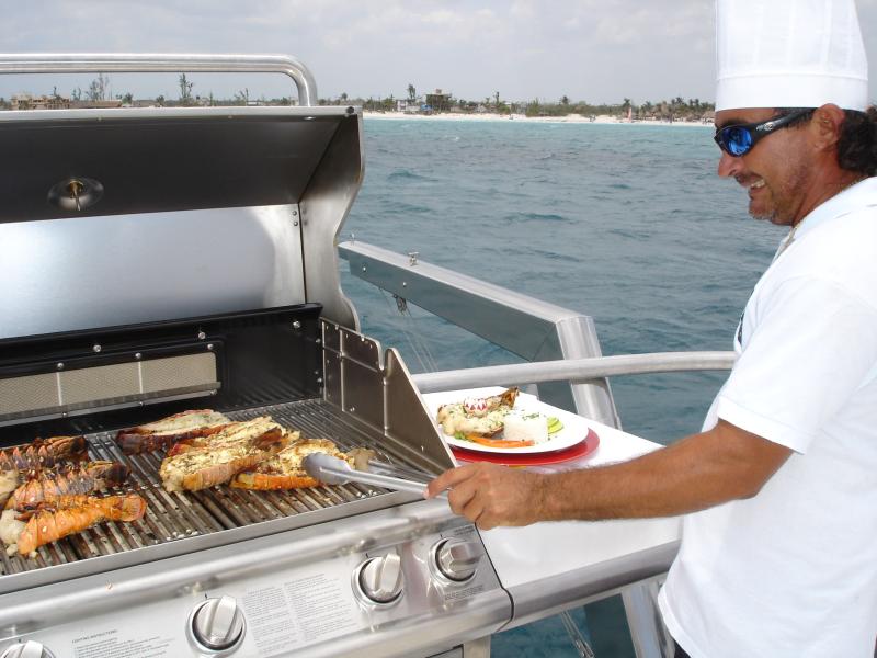 Barbecue on deck of Catamaya catamaran Riviera Maya yacht charter fresh grilled seafood