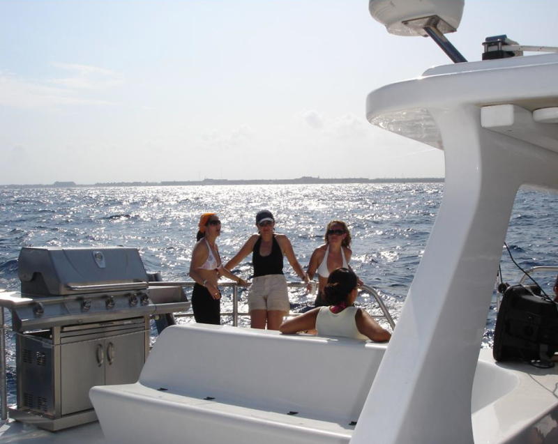 Catamaya catamaran deck area with guests enjoying all-inclusive sailing tour Riviera Maya