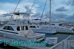 Catamarans and fishing boats at a Puerto Morelos marina on the Riviera Maya reef, south of Cancun for snorkel and sport trips