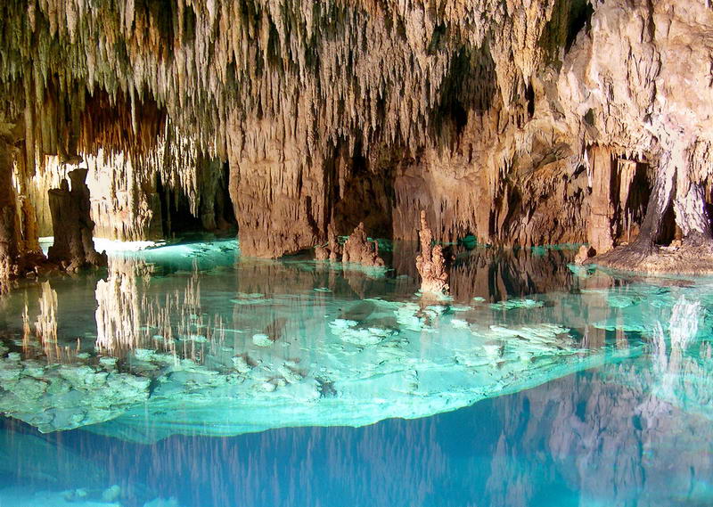 Underground cenote and dramatic rock formations seen along the Aktun Chen cave tour in the Riviera Maya