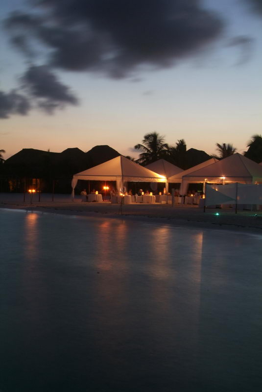 Group beach dinner under the sunset at Maroma, Riviera Maya, with the Caribbean behind