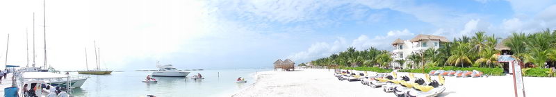 Wave runners and ATVs lined up on the white sand at 
