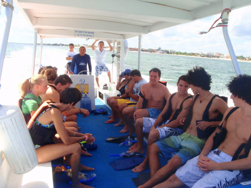 Snorkelers exploring the coral reef in clear water off 