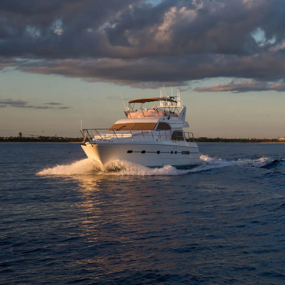 Azimut 60 yacht cruising the Mayan Riviera coastline toward Tulum for a private snorkel and party charter