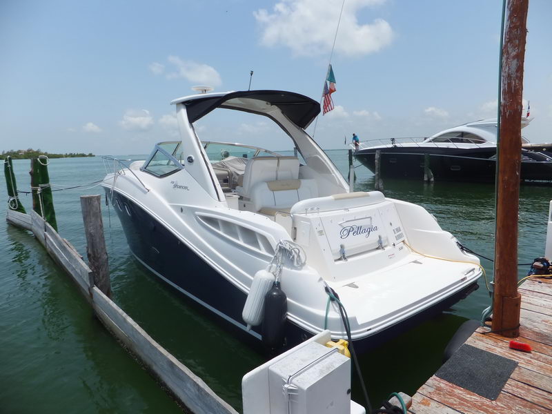 SeaRay Sundancer 330 sport yacht Pellagia stern view at Cancun dock, open cockpit seating and swim platform visible
