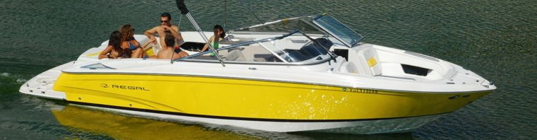 Wide banner-style crop of a bright yellow Regal bowrider on dark green water with about six young people aboard sitting in the bow and cockpit, wakeboard tower and windshield visible, sunny day.